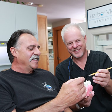 Dr. Aichlmayr talking to a patient about restorative dentistry
